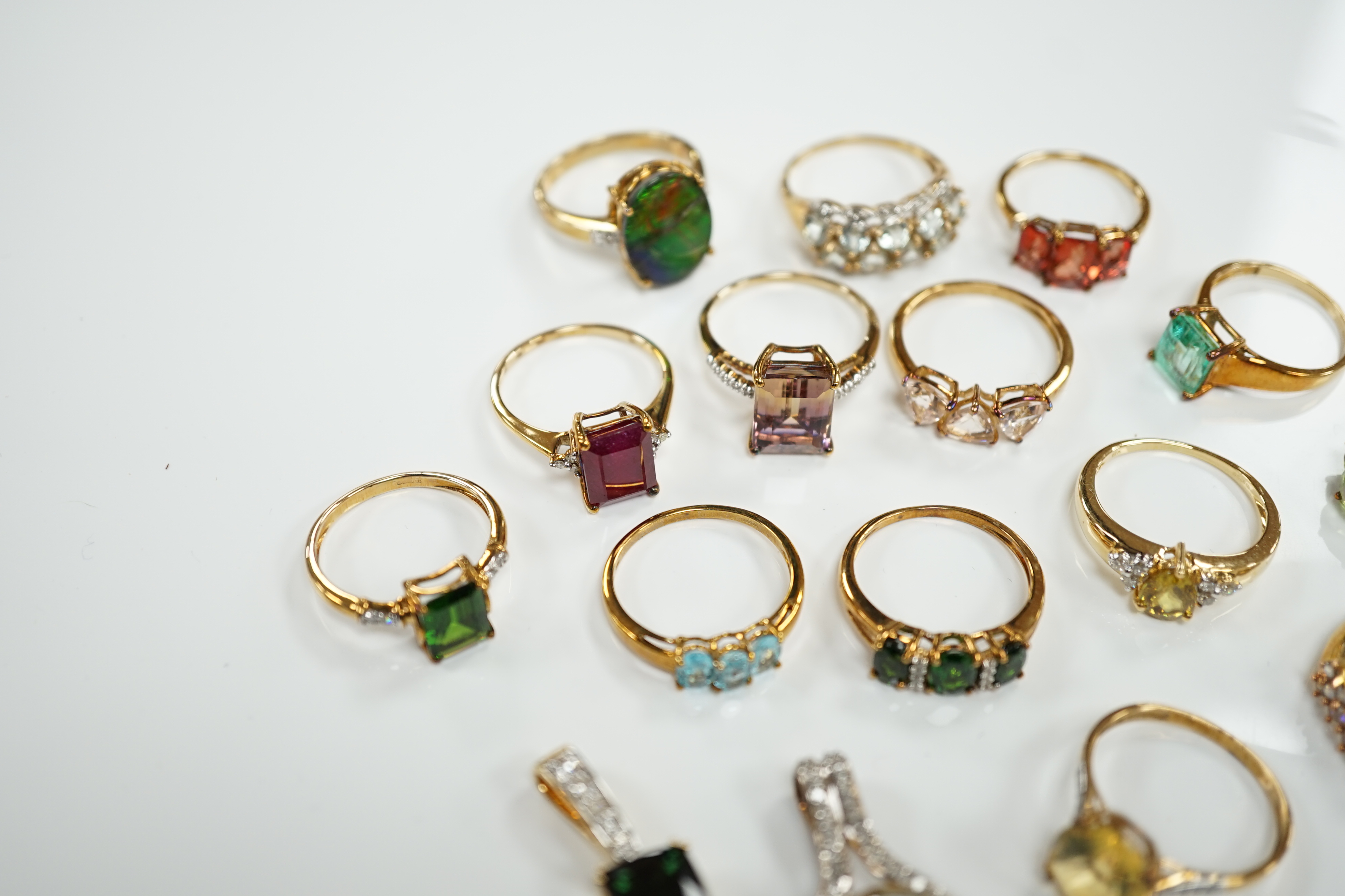 Thirteen assorted modern 9ct gold of 9k and gem set dress rings and a 9ct gold and gem set pendant, gross weight 40.2 grams, together with an 18ct gold, gem and diamond chip set target pendant and an 18ct gold and gem se